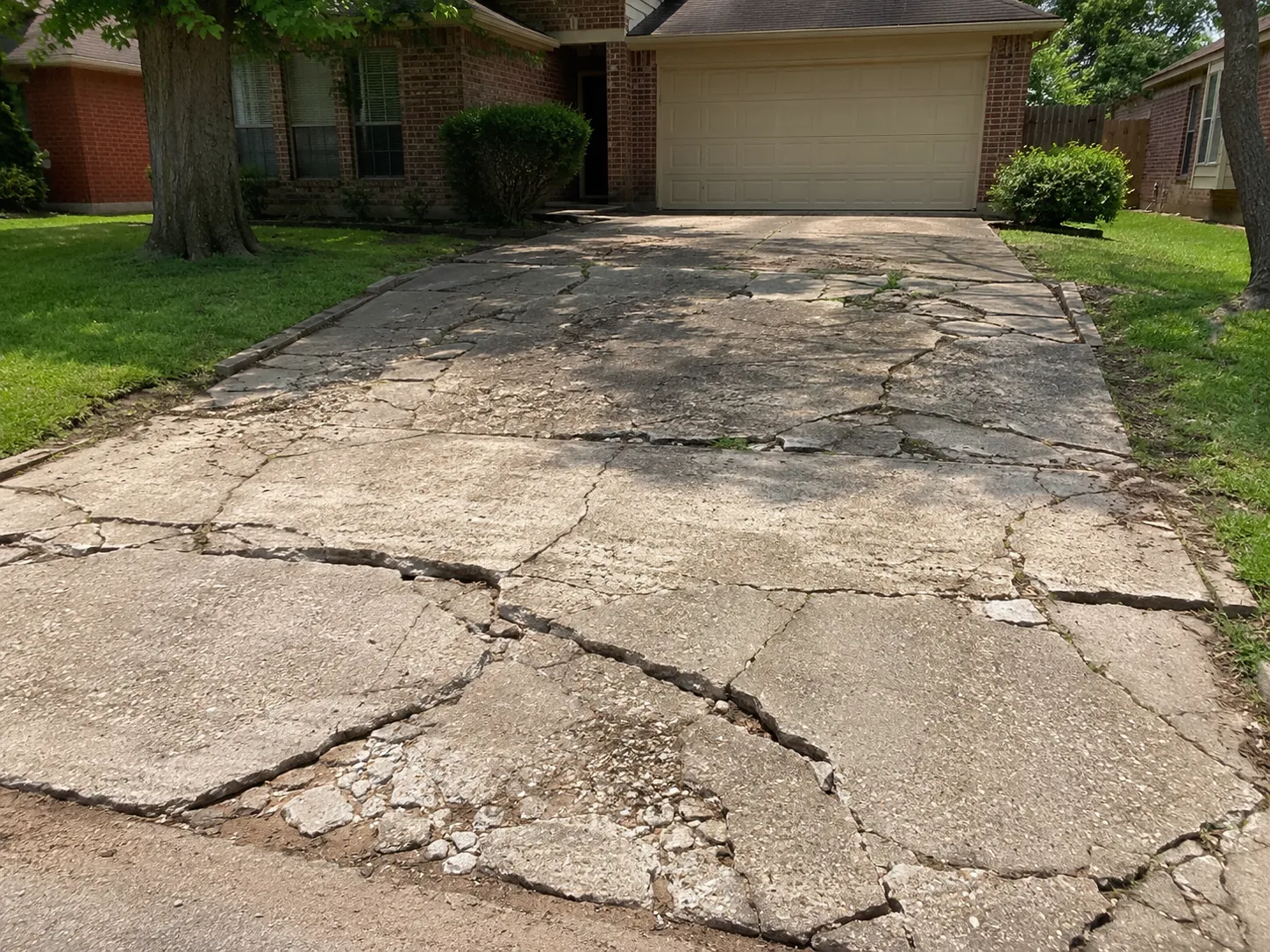 Damaged concrete driveway before replacement