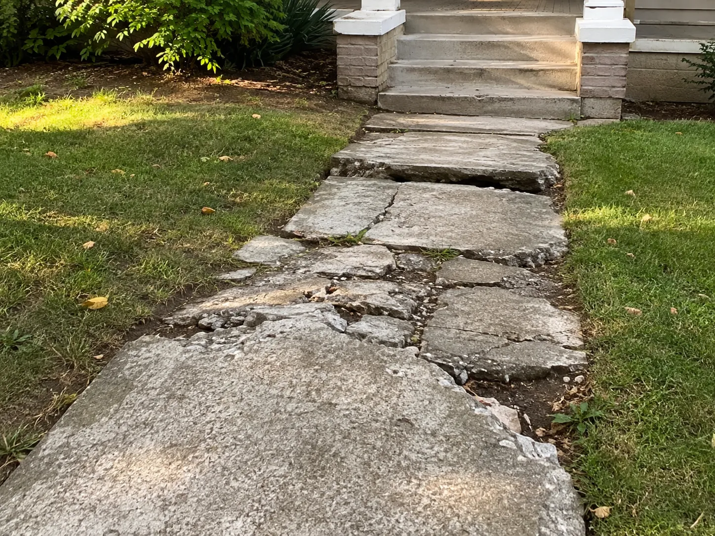 Damaged concrete walkway before replacement